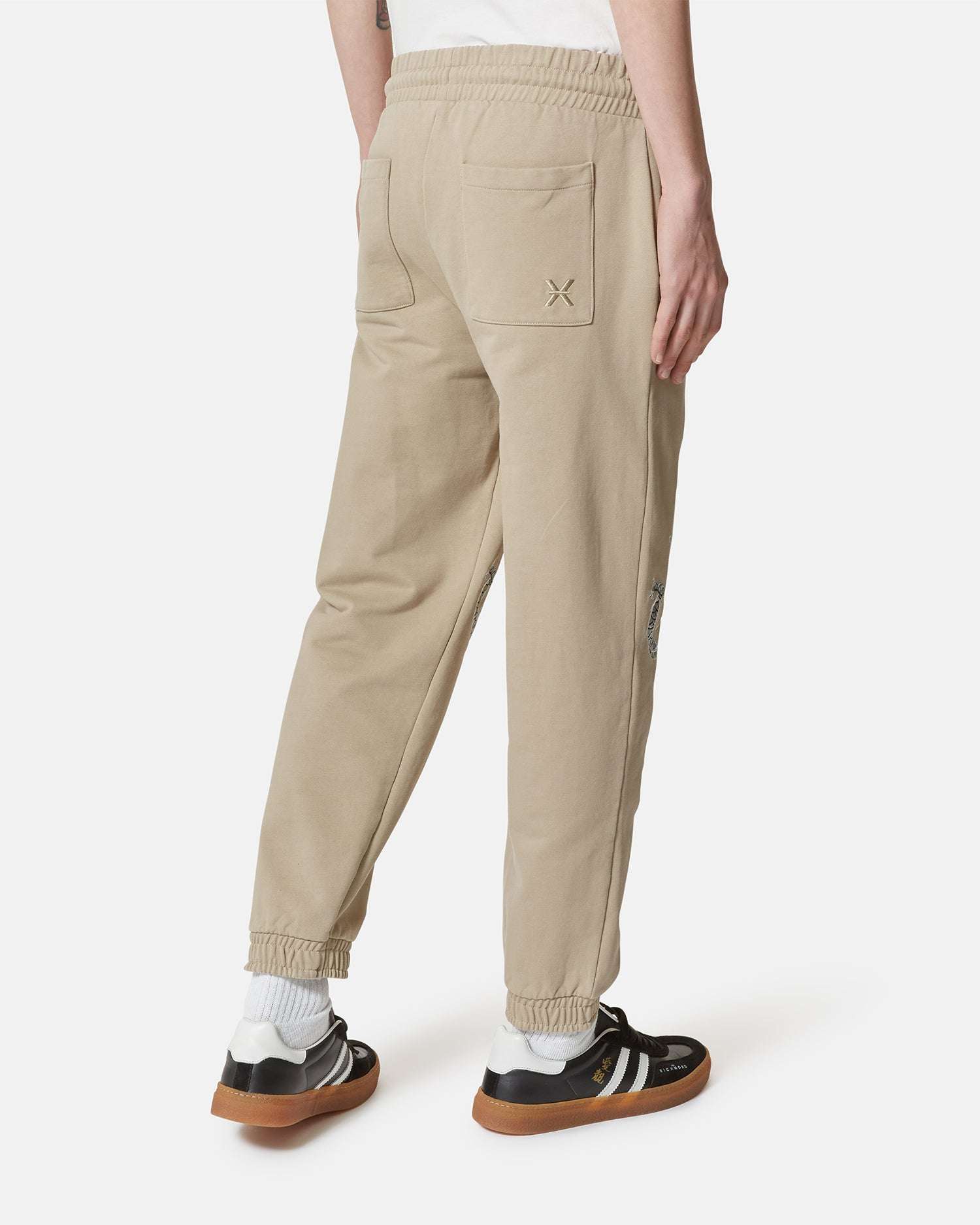 Pantaloni jogger beige con ricami decorativi Pantaloni